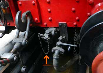 closeup of coupling rod connection on auto-fitted steam locomotive.
