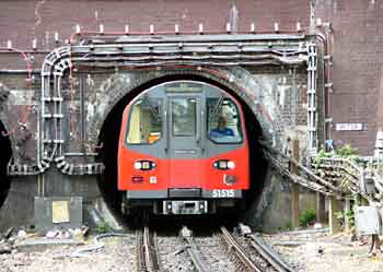 Northern line train exits a tunnel mouth just to the north of Hendon Central station.