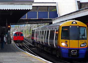 London Overground Class 378 and 1972ts Mk2 Bakerloo line trains pass.