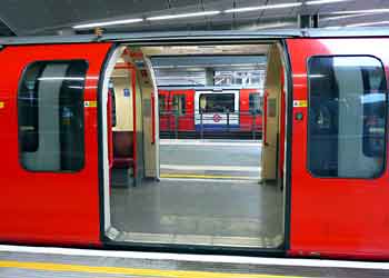 looking through Central line train with doors open on both sides at Stratford Station London.