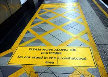 Roadway style cross hatched 'yellow box' at station platform entrance.