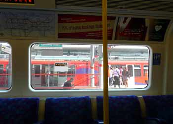 DLR train at Canning Town station as seen through the window of a Jubilee line train.