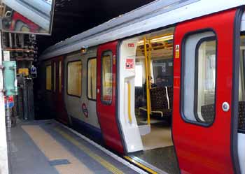 S Stock train at station with one set of doors not open.