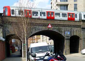 train on railway bridge over Freeston Road in west London.