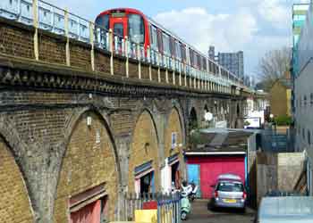S Stock Train on brick arch viaduct.