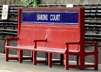 Historic unique seat Barons Court station.