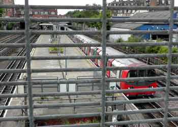 metal mesh railings block view from railway bridge.