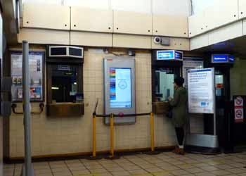 Hants Hill tube station ticket office with customer.