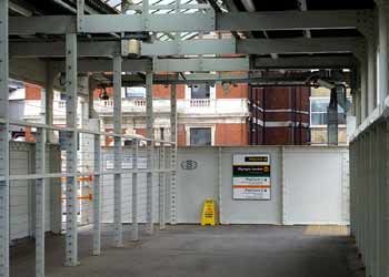 On footbridge over the tracks at Kensington Olympia station.