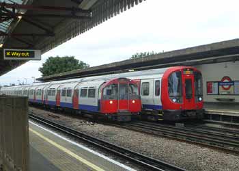 District and Piccadilly line trains at Stamford Brook station.