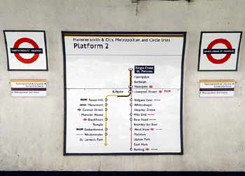 Kings Cross St Pancras station passenger information on tunnel wall.