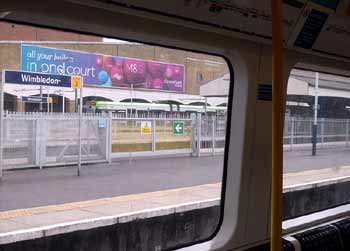 Wimbledon station tram seen from underground train.