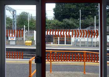 Fully enclosed railway station waiting room doorway.