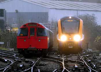 London Overground Class 710 and 1972ts Mk2 Bakerloo line trains pass.