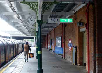 railway station platform with historic canopy metal scrollwork.