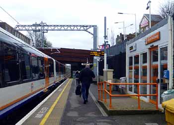 Platform view showing train and waiting room at Upper Holloway station London.
