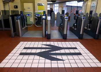 British Rail double arrow floor symbol - ticket gates - West Croydon station.