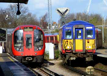 S7 District line and Class 455 720 trains side-by-side at Wimbledon station.