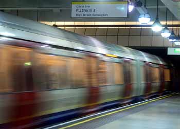 Circle line train departs Gloucester Road station