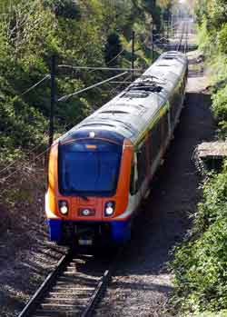 Class 710 train single track branch line.