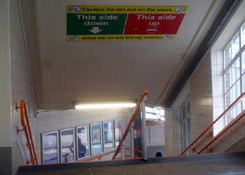 ceiling sign above the stairs at West Croydon station telling passengers to keep left.