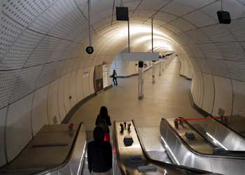 On a descending escalator, arriving at platform level.