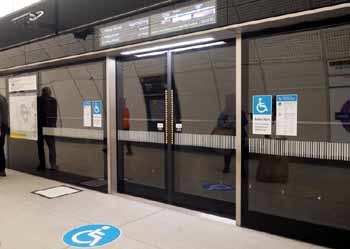 Accessibility markings next to platform screen doors at Elizabeth line station.
