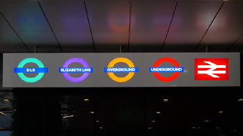 Illuminated train operator logos Stratford station London.