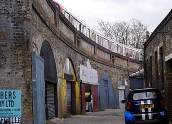 Typical arch shaped workshops below elevated sections of railway in urban areas.