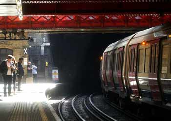 sunshine illuminates the platform at Paddington Underground station.