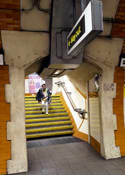 Tufnel Park station running lady staps stairs photo-bomb.