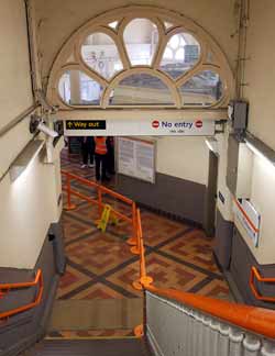 Looking down steps at Camden Road station: see a tiled floor.