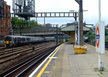 Class 387 Heathrow Express train pases Royal Oak railway station.
