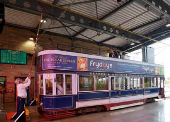 The trolleypole of tram 9 being connected to the overhead wires inside the Seaton Tramway terminus station.