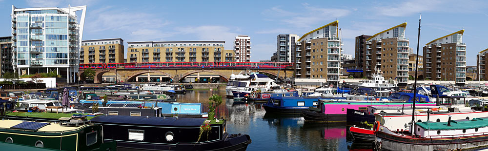 DLR train passes Limehouse Basin boats