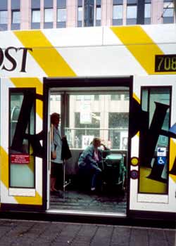 A new low floor tramcar, showing single entry step, flat internal floor and passengers with a child in a pushchair in a special area allocated for accessibility use.