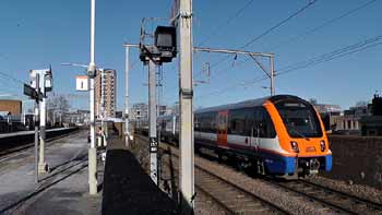 Class 710 train passing London Fields station.