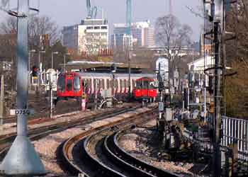 Telephoto lens view of trains at Stamford Brook station.