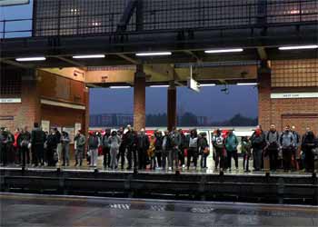 commuters await train at West Ham station.